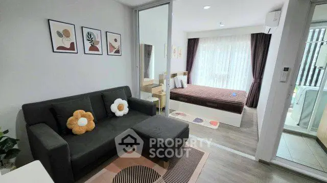 Modern studio apartment with cozy living area and stylish bedroom