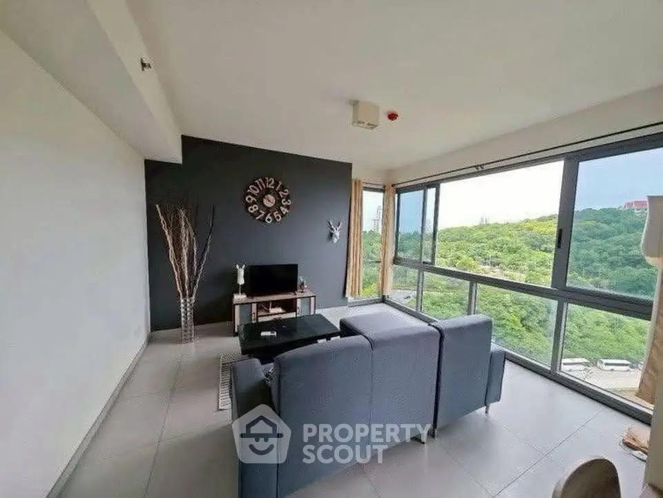 Modern living room with panoramic forest view and stylish decor