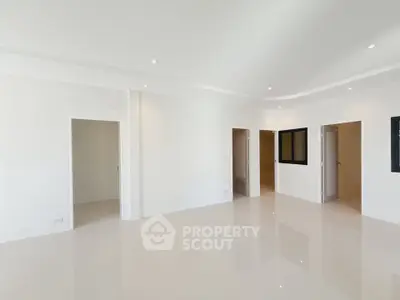 Spacious modern interior with sleek white walls and glossy floors, perfect for customization.