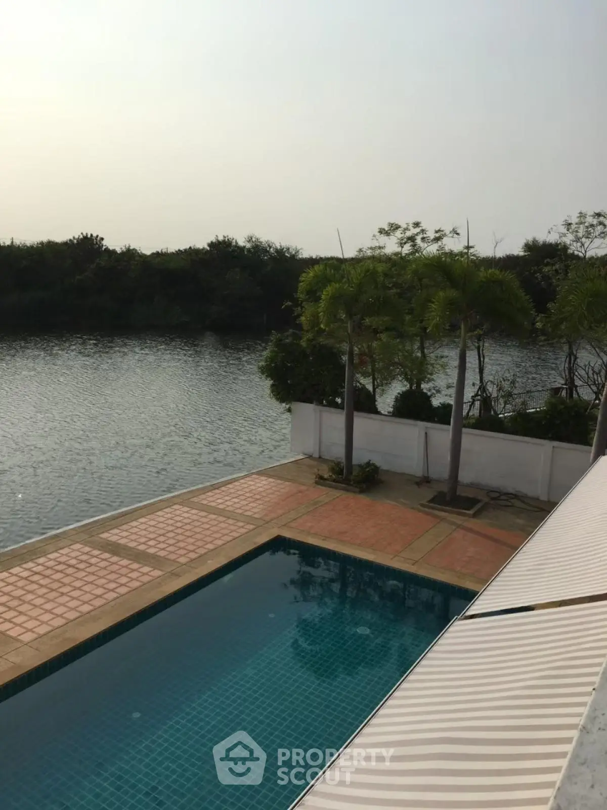 Stunning riverside property with private pool and lush greenery
