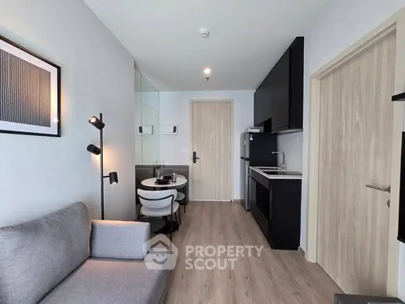 Modern apartment interior with sleek kitchen and cozy living area, perfect for urban living.