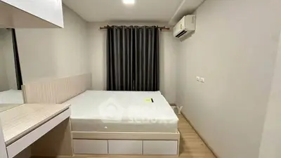 Modern minimalist bedroom with sleek design and air conditioning, perfect for comfortable living.