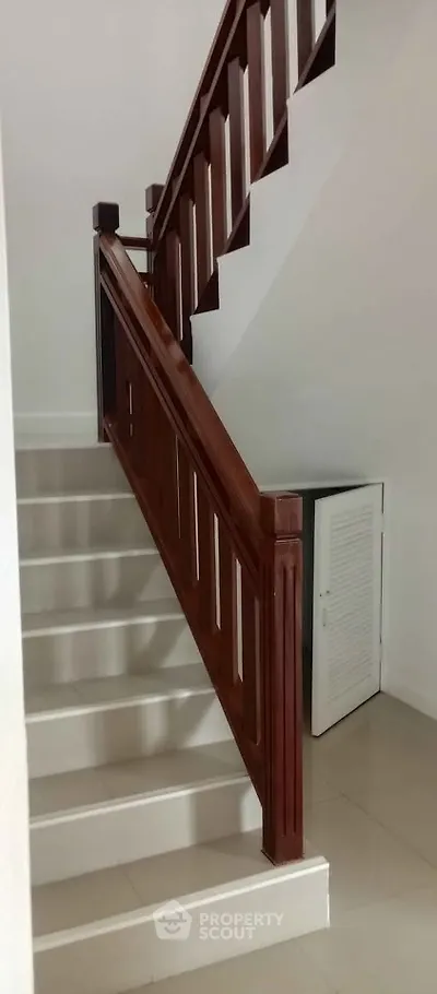 Elegant staircase with wooden railing in modern home interior