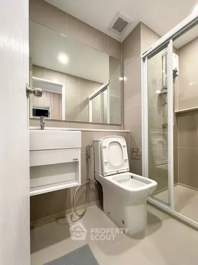 Modern bathroom with sleek fixtures and glass shower enclosure