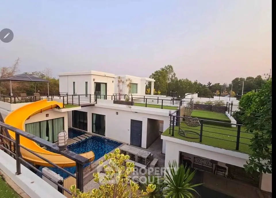 Luxurious modern villa with private pool and rooftop garden, featuring a unique slide for ultimate relaxation.