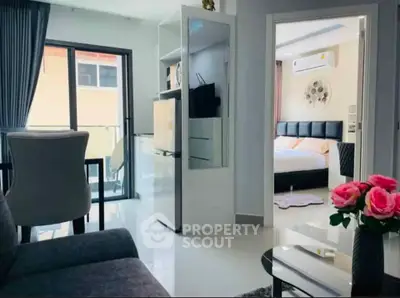 Modern apartment interior with open living room and bedroom, featuring stylish decor and natural light.