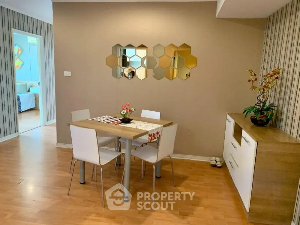 Stylish dining area with modern decor and wooden flooring in a cozy apartment.