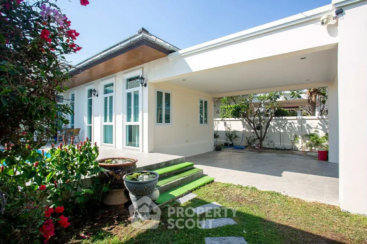 Charming single-story home with lush garden and spacious patio area.