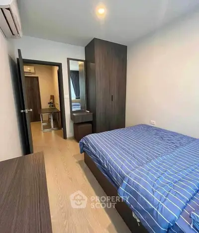 Cozy bedroom with modern furnishings and ample natural light, perfect for relaxation and comfort.