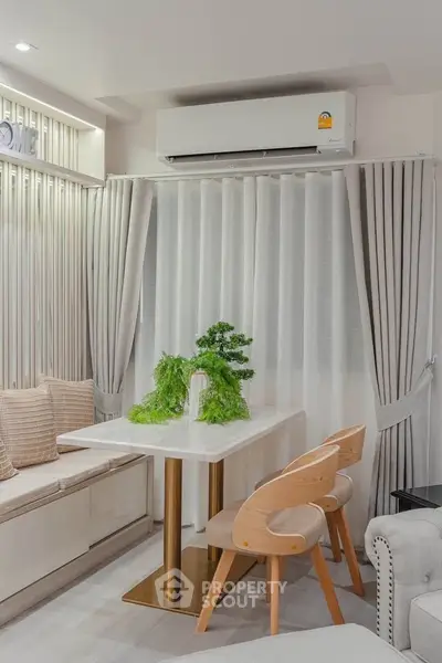 Modern living room with elegant dining area and stylish decor