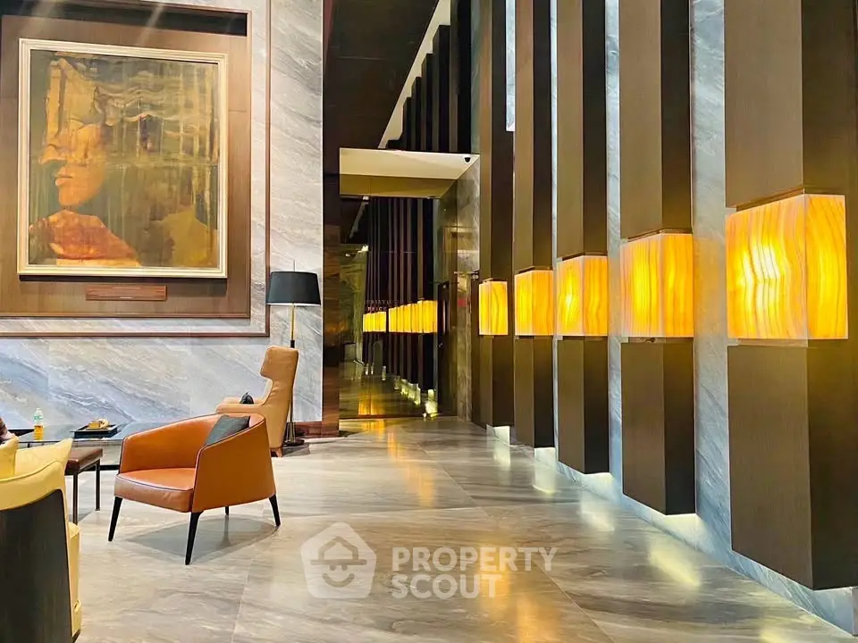 Luxurious lobby with modern lighting and elegant seating in upscale building.
