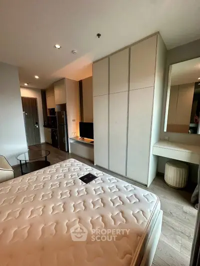 Modern bedroom with stylish furniture and built-in storage in a contemporary apartment.