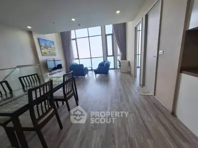 Spacious modern living room with large windows and elegant decor