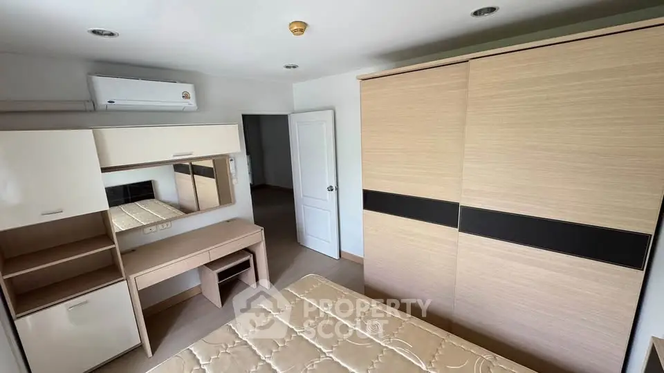 Spacious bedroom with modern furniture and ample storage space