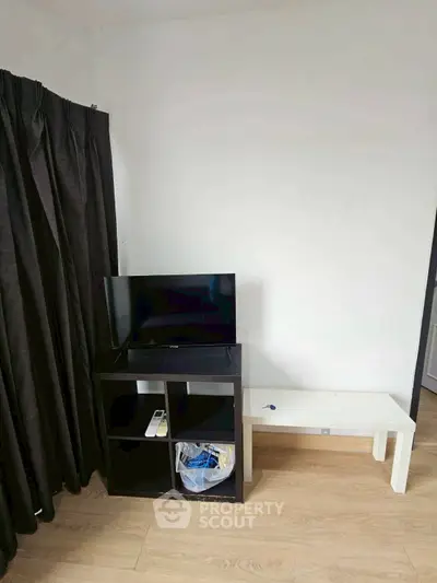 Compact living room with TV stand and minimalist decor