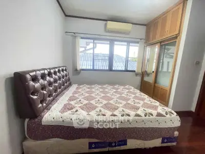 Cozy bedroom with large bed and ample natural light from window
