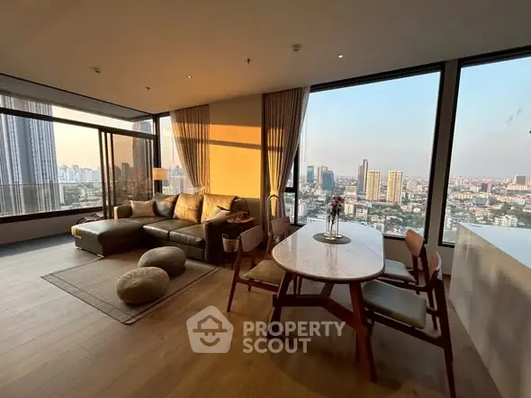 Luxurious living room with panoramic city view and elegant furnishings.