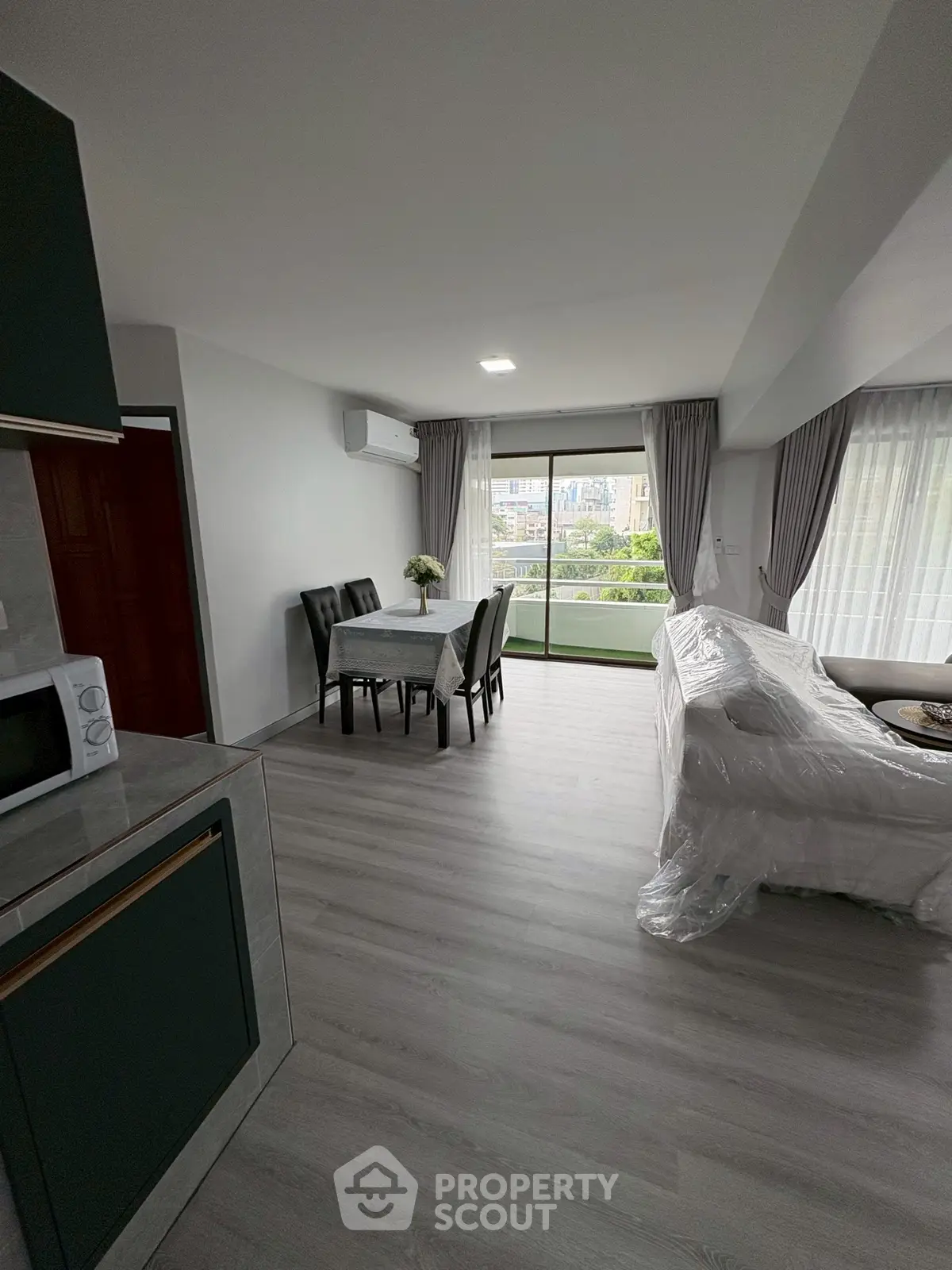 Spacious modern living room with dining area and large windows for natural light.