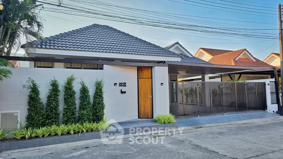 Charming modern house with sleek design and lush greenery in a serene neighborhood.