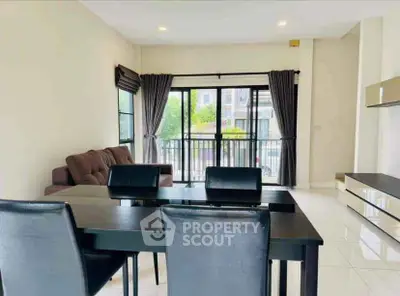 Spacious modern living room with dining area and balcony view