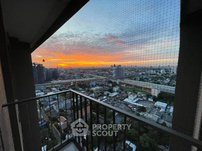 Breathtaking cityscape view from a high-rise balcony at sunset, showcasing a vibrant sky and urban panorama, perfect for relaxation and entertainment.