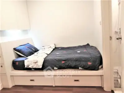 Cozy bedroom with built-in storage bed and modern decor, perfect for urban living.