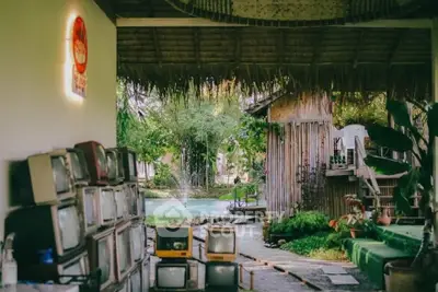 Charming rustic outdoor space with vintage TVs and lush greenery
