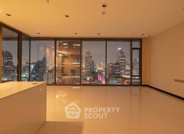 Luxurious high-rise apartment with stunning city skyline view at night.