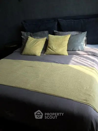 Cozy bedroom with stylish bedding and soft lighting