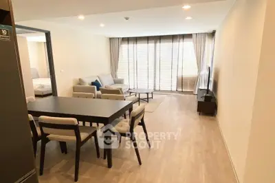 Spacious modern living room with dining area and large windows