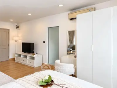 Spacious modern bedroom with stylish furniture and natural light