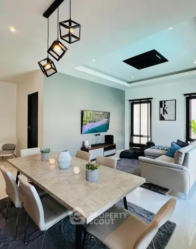 Modern living room with stylish dining area and contemporary lighting