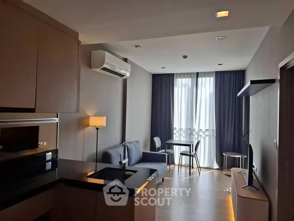 Modern living room with sleek furniture and natural light, featuring a cozy sofa and stylish decor.