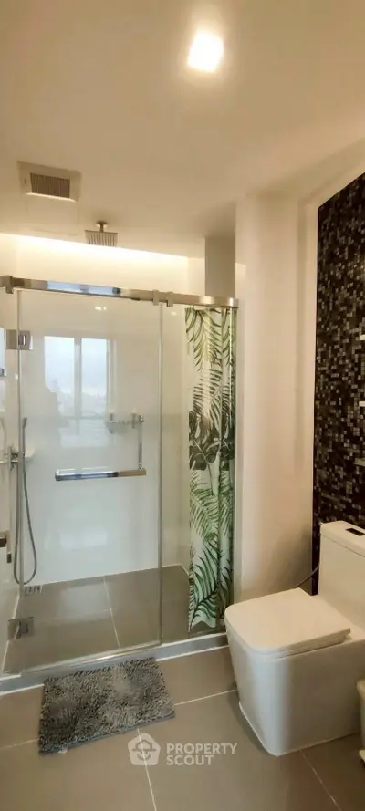 Modern bathroom with glass shower and stylish tile design