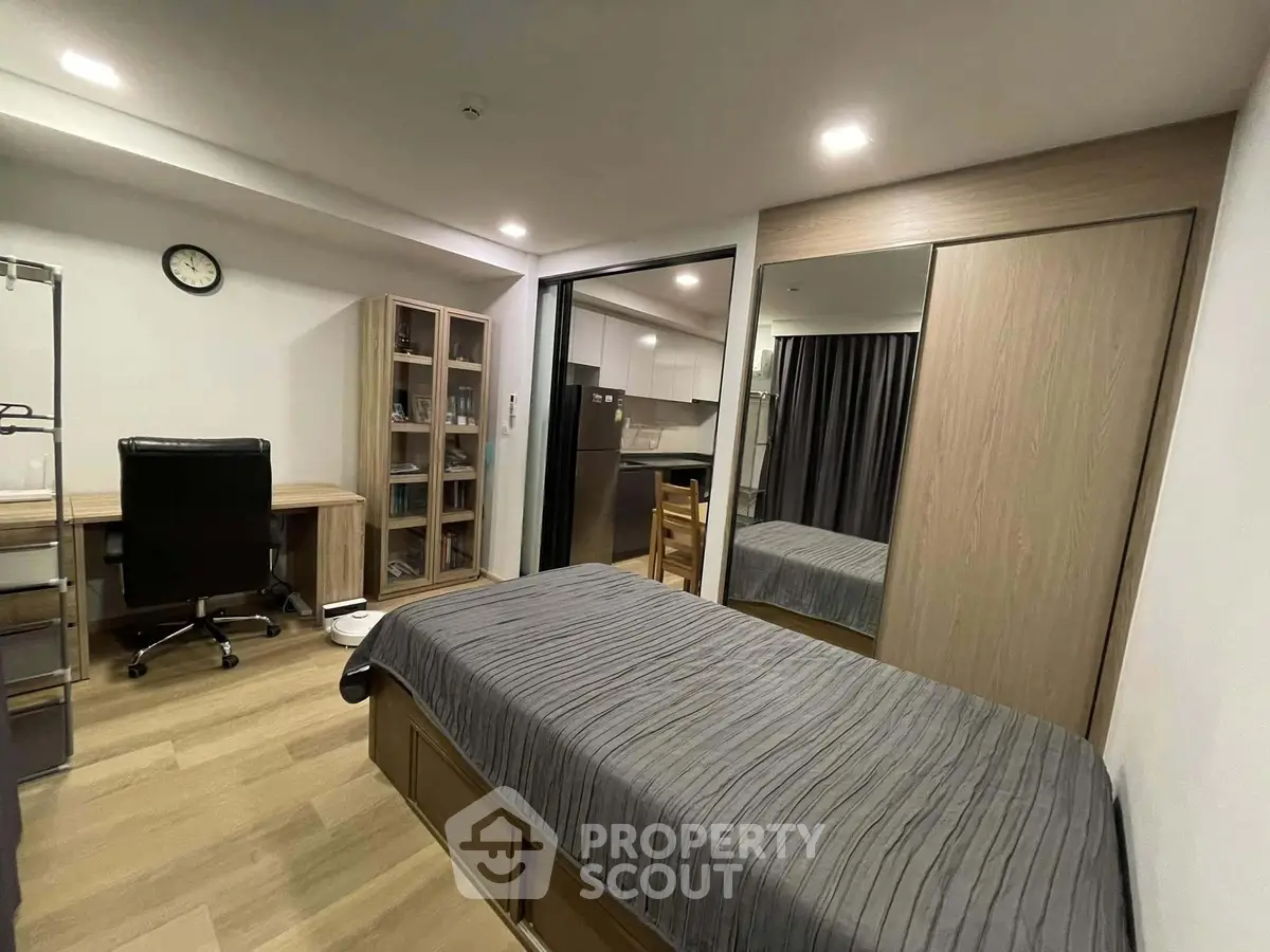 Modern bedroom with study area and sleek design in urban apartment