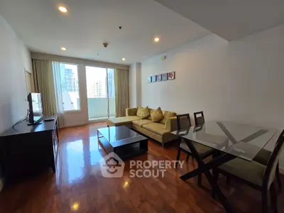 Spacious living room with modern furniture and city view, perfect for urban living.