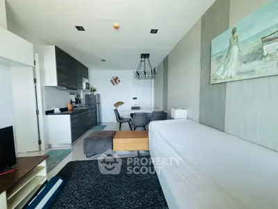 Modern open-layout living room with sleek kitchen and stylish decor