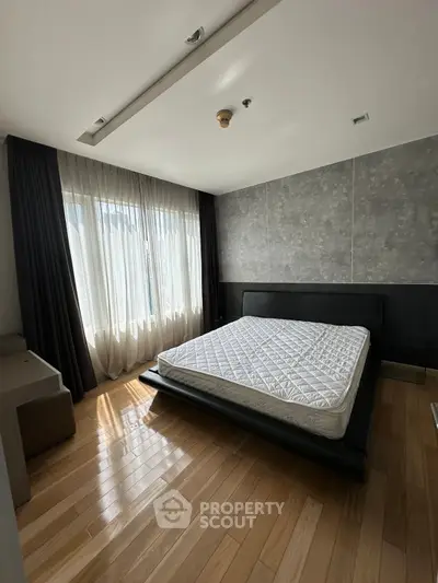 Spacious bedroom with modern design and large window for natural light
