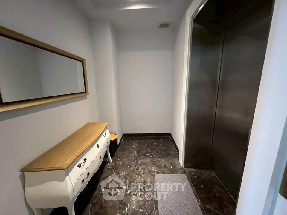 Elegant elevator lobby with stylish console table and large mirror
