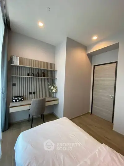 Modern bedroom with study area, featuring sleek design and ample natural light.