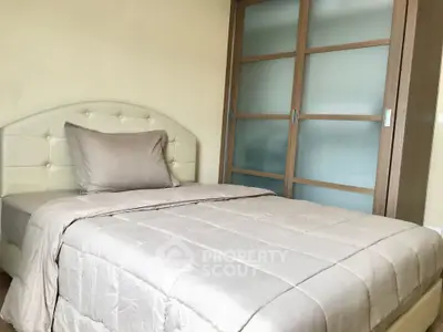 Cozy bedroom with modern sliding door wardrobe and elegant bedding