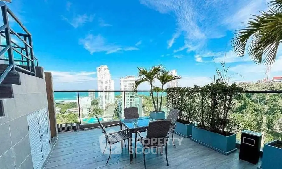 Stunning rooftop terrace with ocean view and modern outdoor furniture.