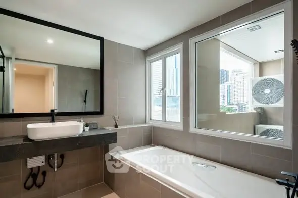 Modern bathroom with large window and city view