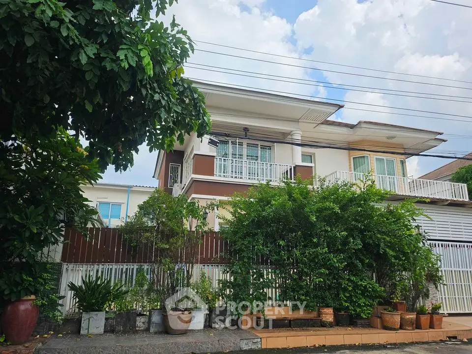 Charming two-story house with lush garden and spacious balcony in serene neighborhood.