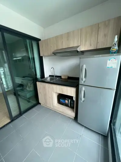 Modern kitchen with sleek appliances and gas stove in contemporary home