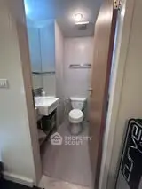 Compact modern bathroom with sleek fixtures and efficient design.