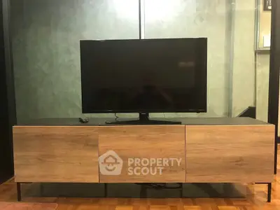 Modern living room with sleek TV stand and flat-screen television, perfect for entertainment setup.