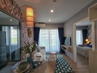 Modern living room with stylish decor and open layout leading to a cozy bedroom.
