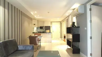 Modern open-plan living room with stylish decor and sleek kitchen area.