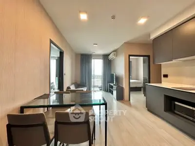 Modern open-plan living room with sleek kitchen and dining area